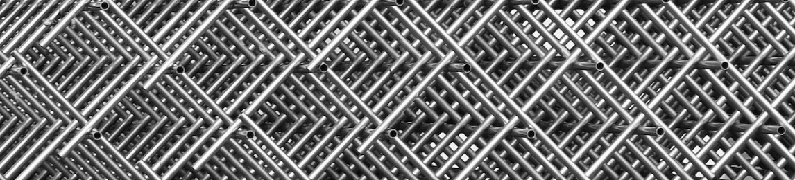 Multiple layers of welded wire mesh used for stucco wall reinforcement, stacked for construction use.